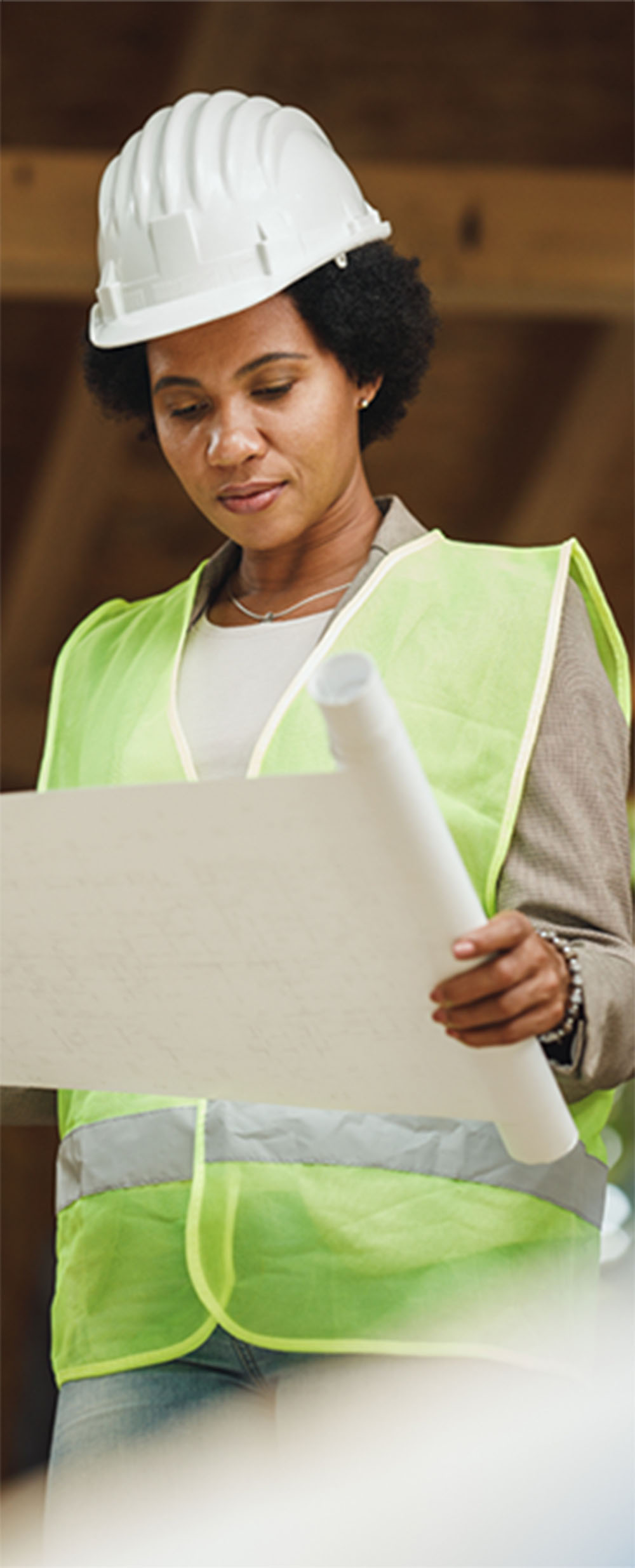 construction worker on site with plans